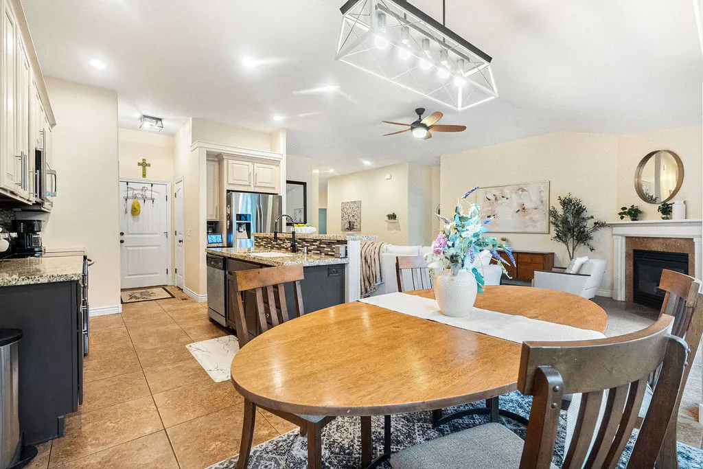 Open concept living area with vaulted ceiling, recessed lighting, and a ceiling fan
