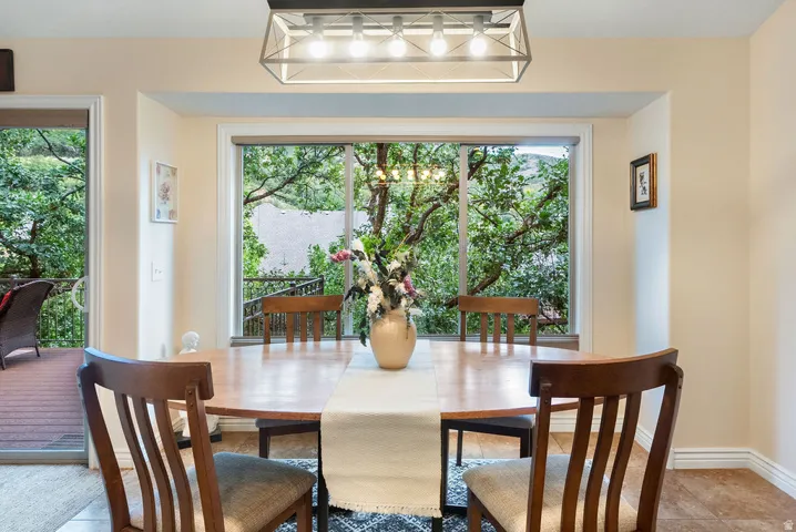 Expansive bay window, recessed lighting, tile flooring, and direct patio access