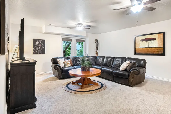 Recessed lighting, ceiling fans, and light-colored carpeting