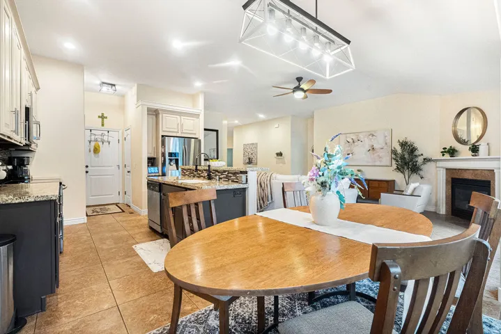 Open concept living area with vaulted ceiling, recessed lighting, and a ceiling fan