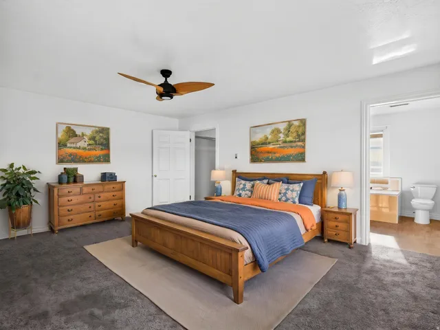 Neutral wall tones, recessed lighting, ceiling fan with wood-finish blades, and carpet flooring