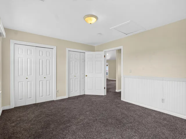 Plush carpeting, multiple closet storage options, recessed lighting, and wainscoting