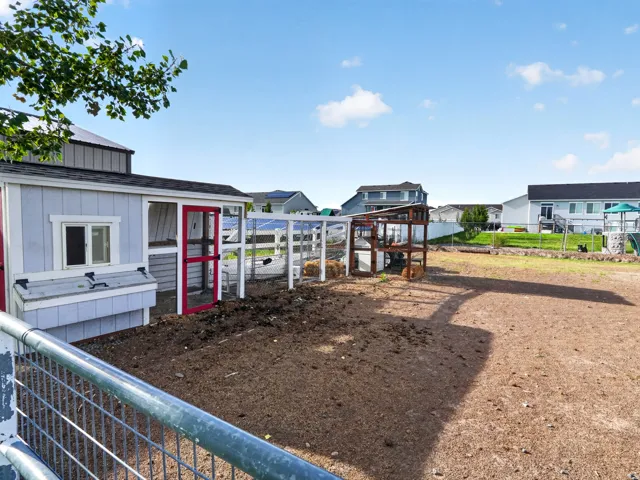 Dedicated animal enclosure featuring a light blue exterior, red-trimmed doors, and multiple fenced areas