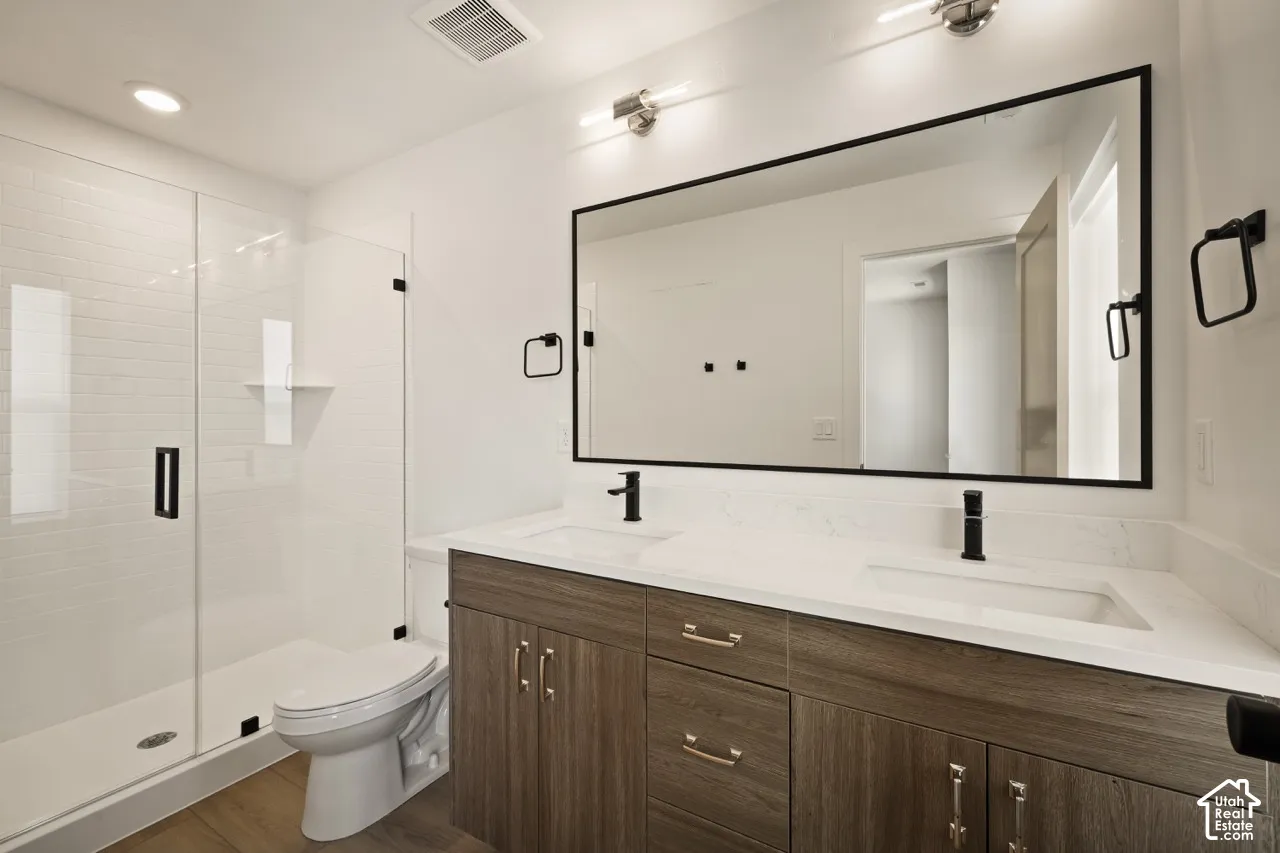 Frameless glass shower enclosure with white subway tile