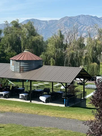 Covered outdoor patio with metal roof and integrated silo-style structure