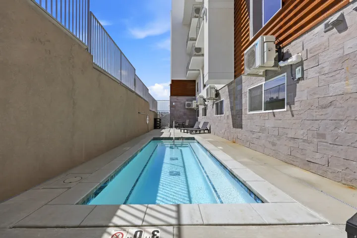 Swimming pool with tile coping and a surrounding concrete deck