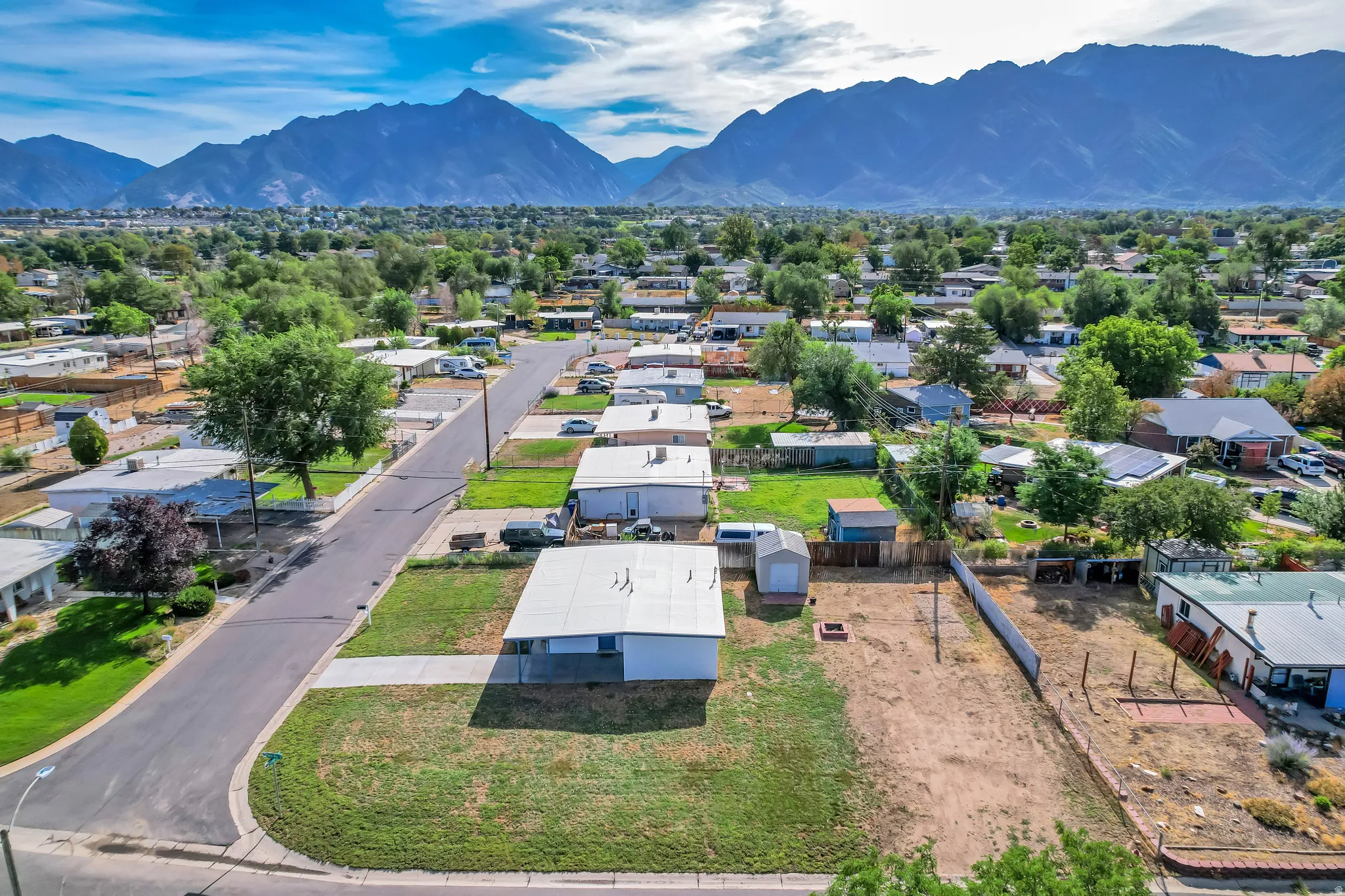 Expansive lot featuring a large open area, a detached storage shed, and a covered patio area