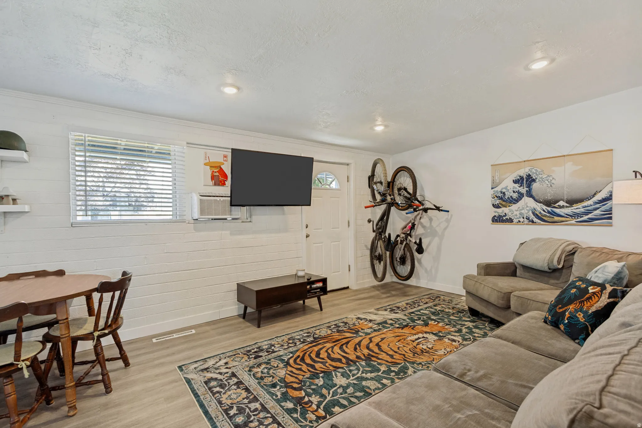 Recessed lighting, wood-finish flooring, white shiplap wall, and a window with blinds