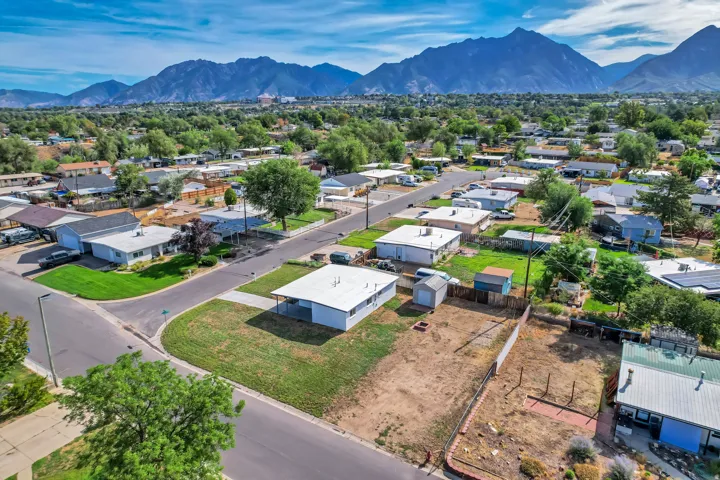 Mountain backdrop, residential neighborhood, paved streets, and established trees