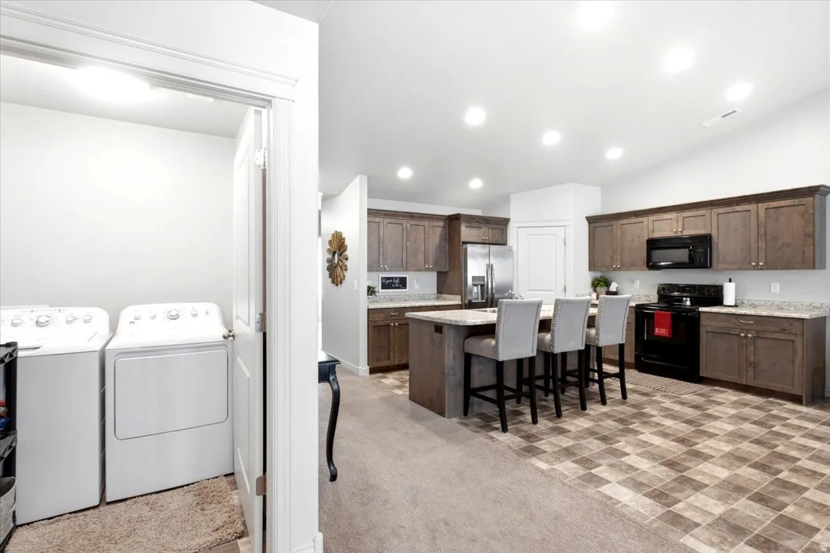 Kitchen with wood-finish cabinetry, light-toned countertops, and checkerboard floor tiling