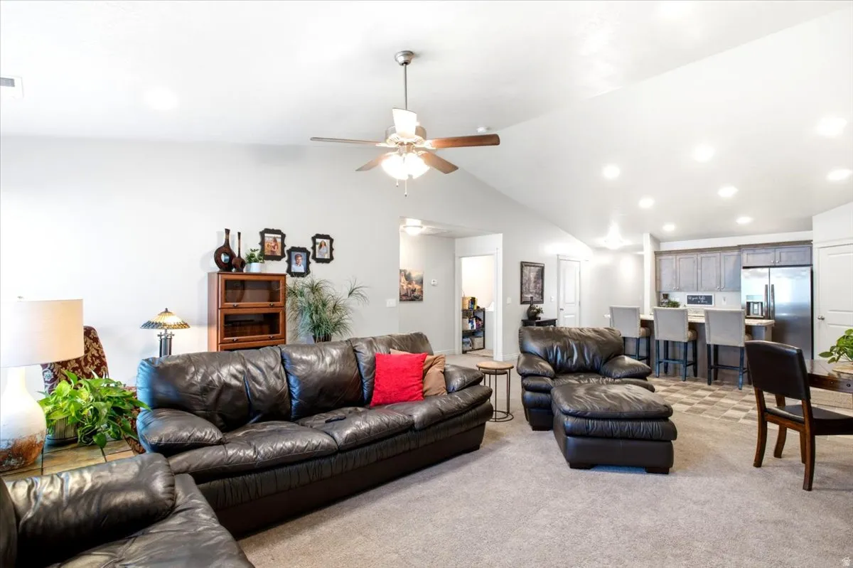 Vaulted ceiling, recessed lighting, and a ceiling fan