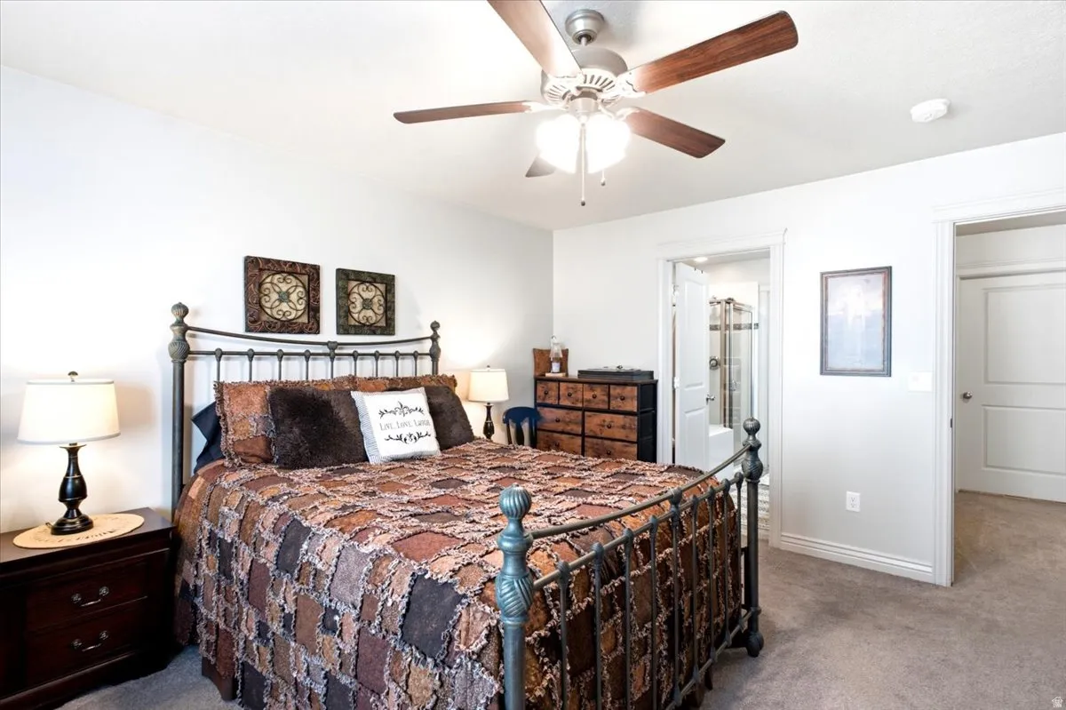 Ceiling fan with light fixture, carpeted flooring, white walls, and white trim