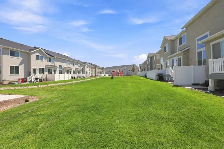 Expansive green space bordered by residential structures