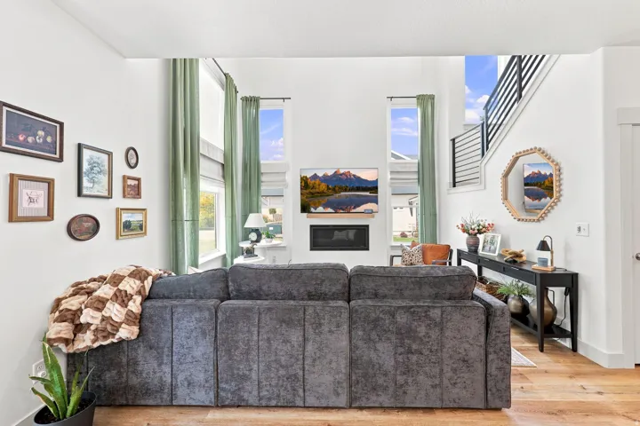 Double-height ceilings complement the fireplace with a mounted television