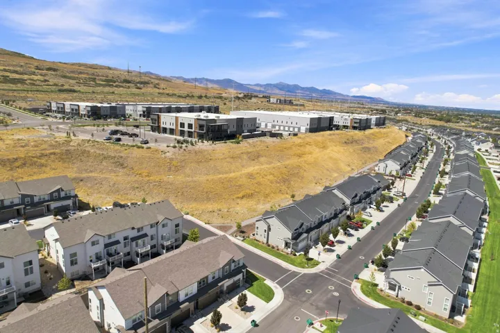 Newly developed residential community featuring modern townhome-style architecture with clean linear rooflines and neutral exterior finishes