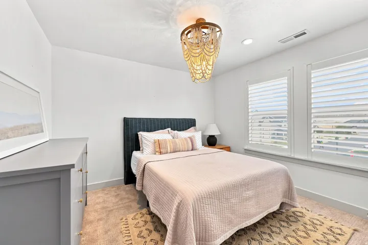 Recessed lighting, warm wood-finish flooring, and white walls create a bright and inviting atmosphere