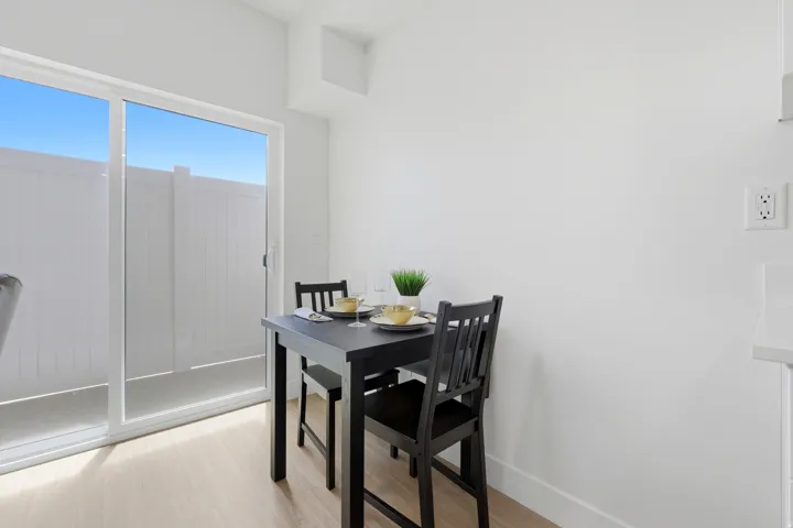Sliding glass door, wood-finish flooring, white wall finishes
