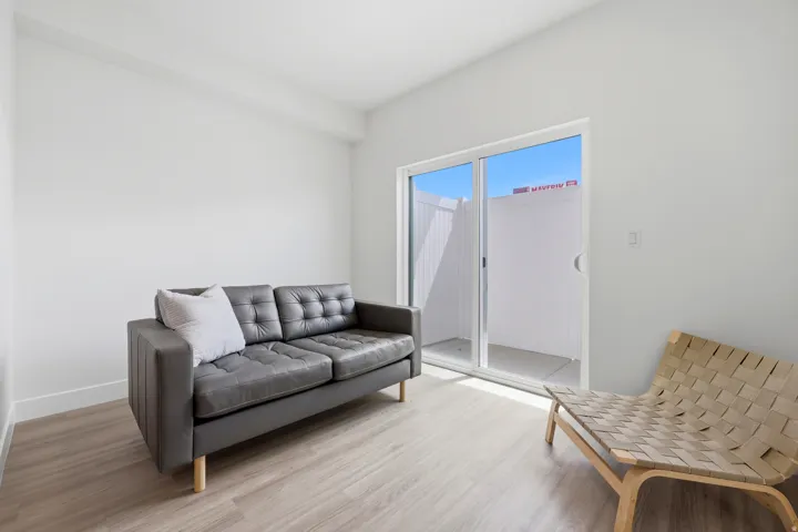 Light wood-finish flooring with white walls and a white ceiling