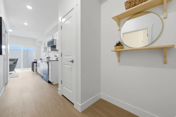 Recessed lighting illuminates the wood-finish flooring