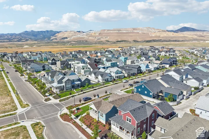 Modern residential development with a variety of architectural styles, paved streets, sidewalks, and landscaped common areas