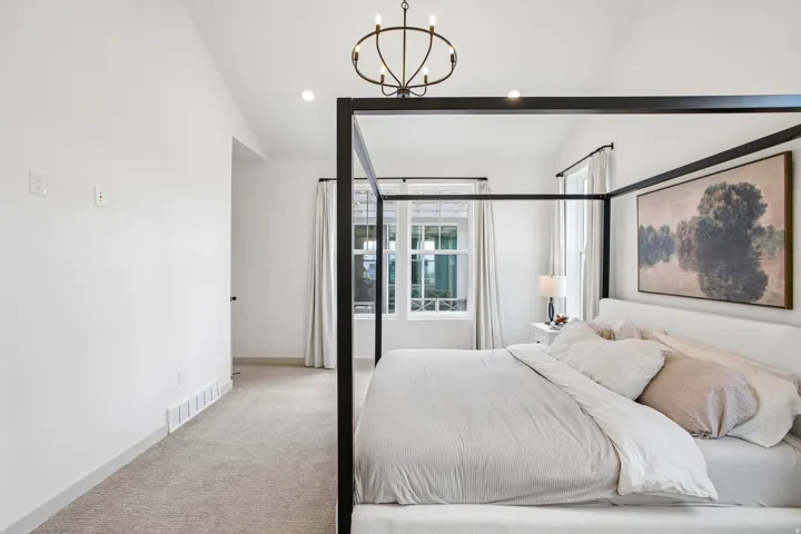 Vaulted ceilings, recessed lighting, and a contemporary chandelier