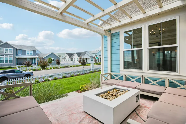 Covered patio featuring a built-in fire pit, pergola, built-in bench seating, and an accent wall with board and batten siding