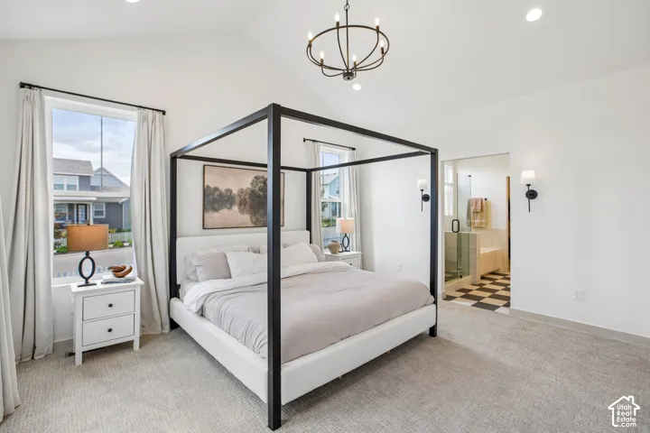 Vaulted ceiling with an overhead chandelier, recessed lighting, and soft carpet flooring