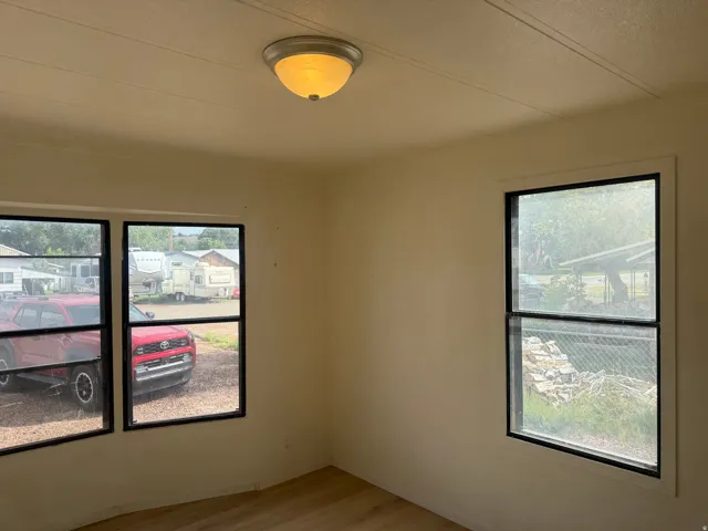 Two large windows, a single window, and a flush mount ceiling light fixture
