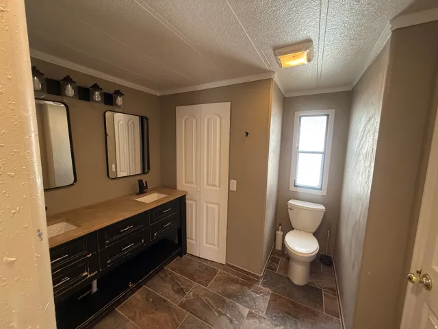 Dual vanity with undermount sinks and black-finish hardware, rectangular mirrors, and a multi-light fixture