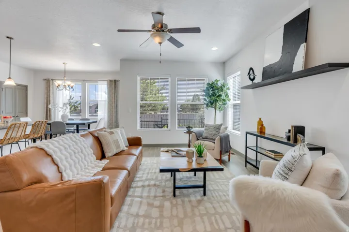 Recessed lighting, ceiling fan, wood-finish flooring, multiple windows with blinds, and built-in shelving