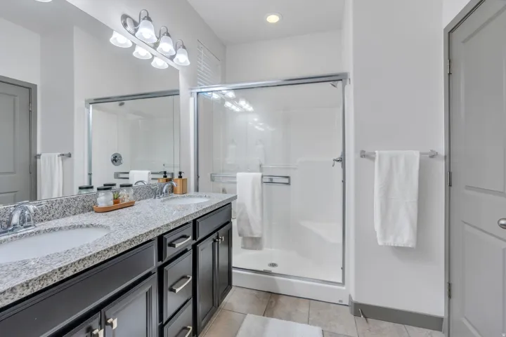 Dual vanity with speckled countertops and undermount sinks