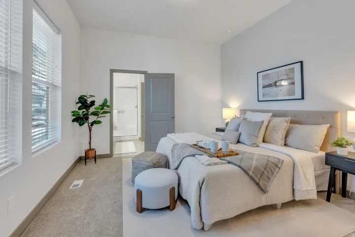 Plush carpeting, multiple windows with blinds, light gray interior door, recessed lighting, and a neutral wall color
