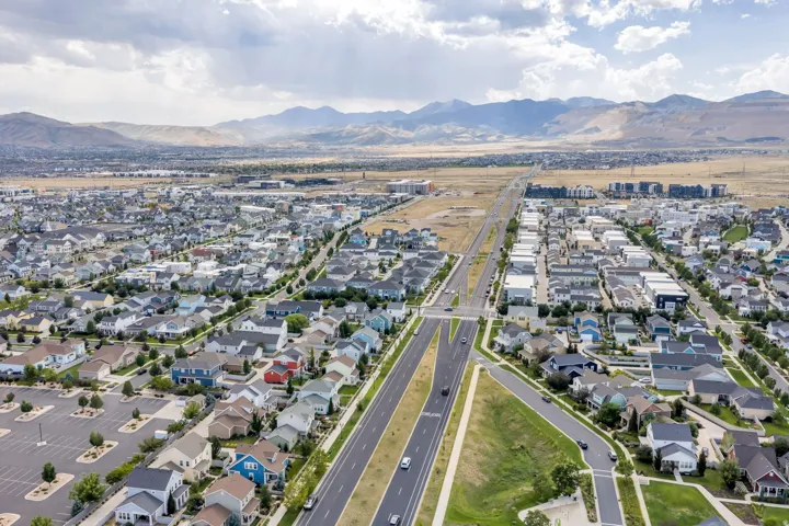 Expansive neighborhood with diverse architectural styles, wide paved roads, and ample street parking
