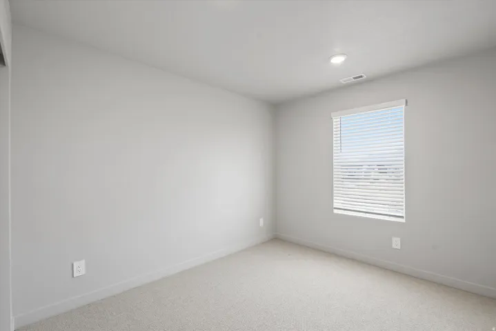 **Disclaimer** Interior package has upgrades not photographed.  Recessed ceiling light, carpeted flooring, window with horizontal blinds, and neutral wall tones