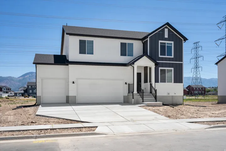 **Disclaimer** Exterior elevation may vary. Two-story exterior with a two-car garage, front porch, and concrete driveway