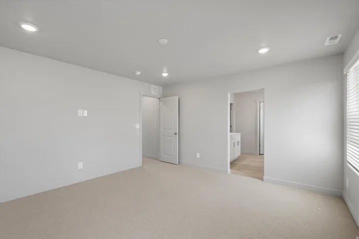 **Disclaimer** Interior package has upgrades not photographed.  Recessed ceiling lighting, neutral-toned walls, and soft carpet flooring