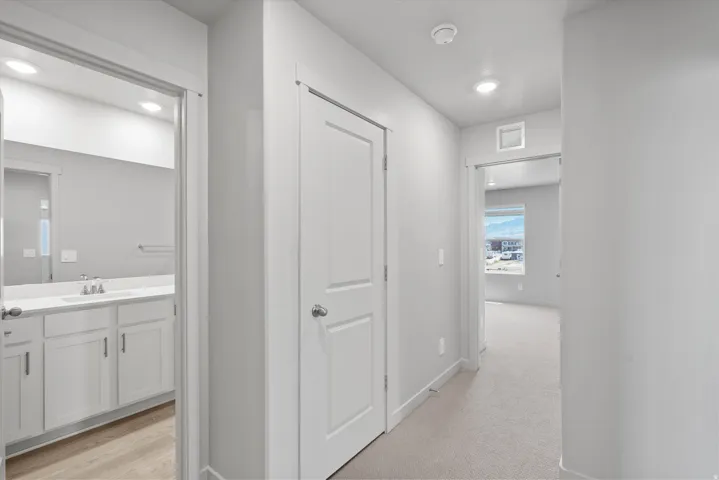 **Disclaimer** Interior package has upgrades not photographed.  Neutral color palette, recessed lighting, white interior doors, wood-finish flooring, and light-toned carpeting