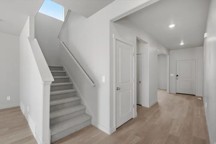 **Disclaimer** Interior package has upgrades not photographed.  Carpeted staircase with a skylight overhead