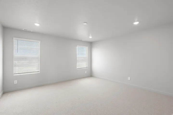 **Disclaimer** Interior package has upgrades not photographed.  Recessed ceiling lighting, light neutral-toned carpeting, two windows with horizontal blinds