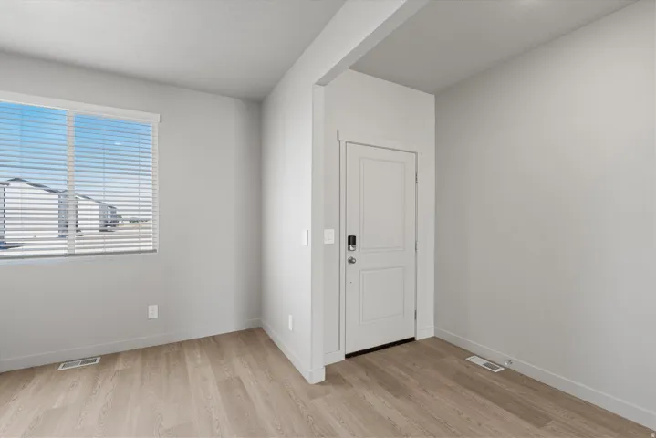 **Disclaimer** Interior package has upgrades not photographed.  Wood-finish flooring, white trim, and a window with blinds