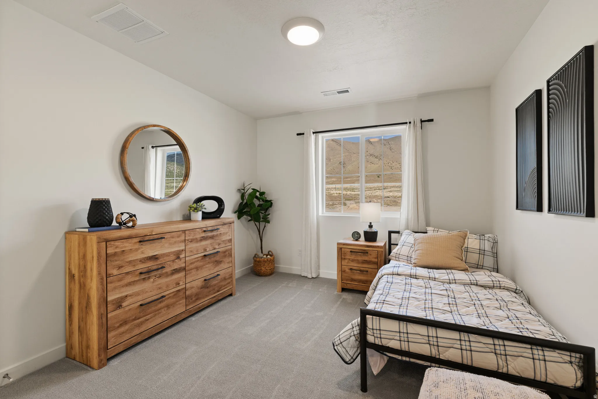 White walls with a single window, recessed lighting, and light gray carpeting