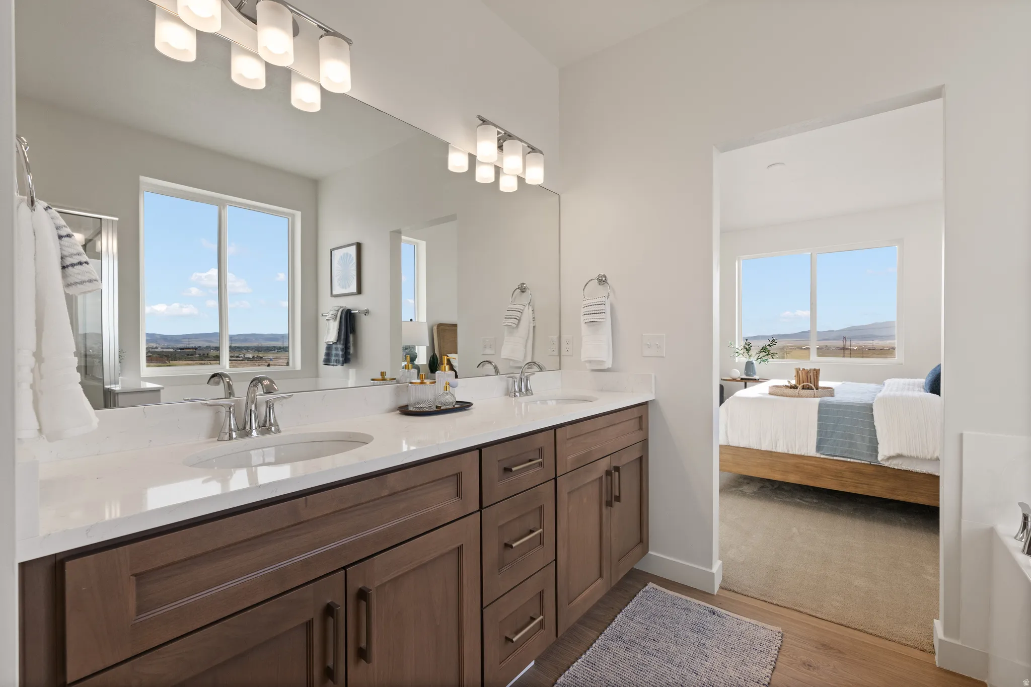 Double vanity with dual undermount sinks, integrated countertop, and modern wood-finish cabinetry