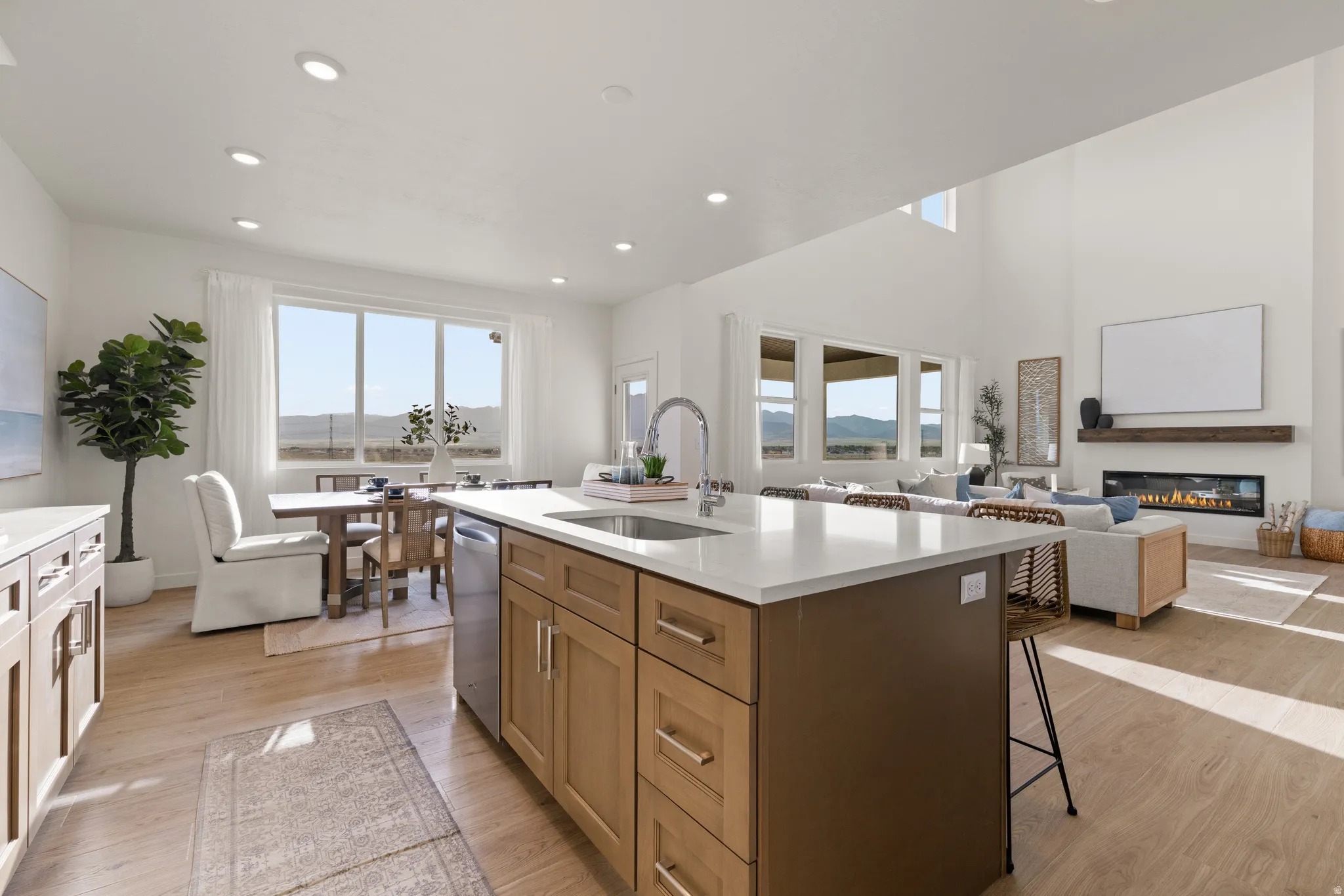 Gourmet kitchen with a large island and light wood-finish flooring
