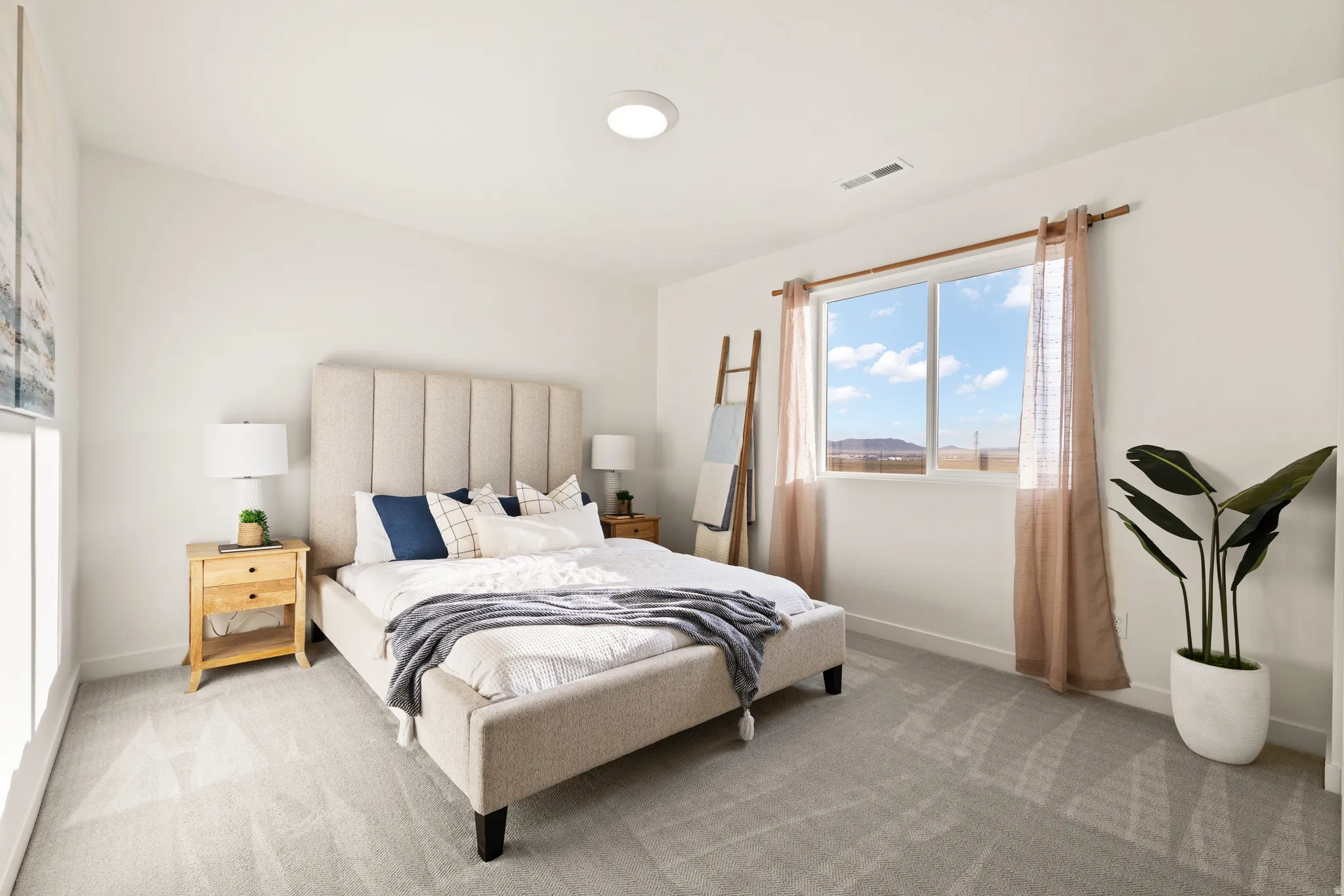 Neutral wall color, recessed lighting, expansive window, light gray carpeting, and white trim