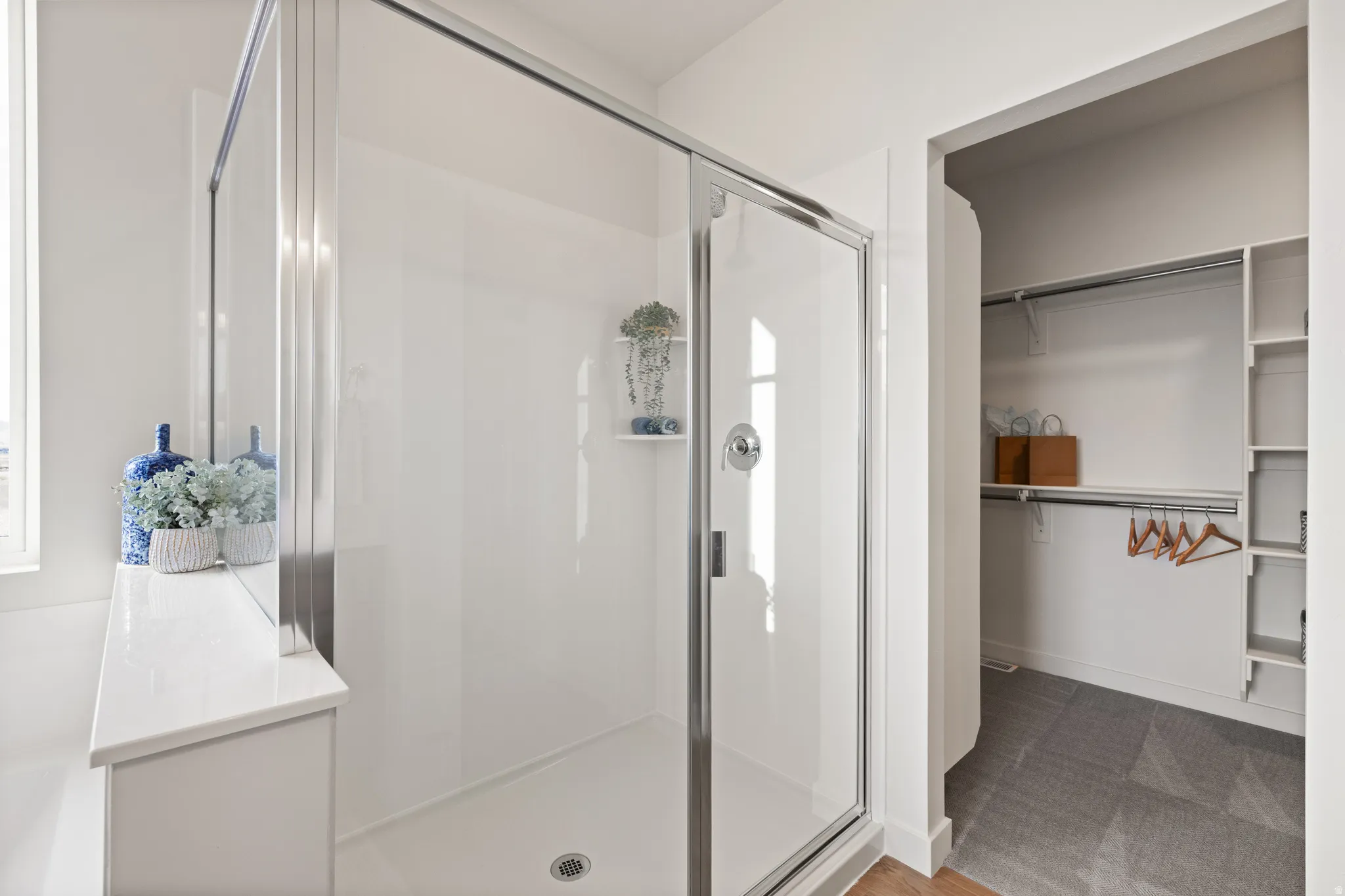Glass-enclosed shower with a chrome shower fixture