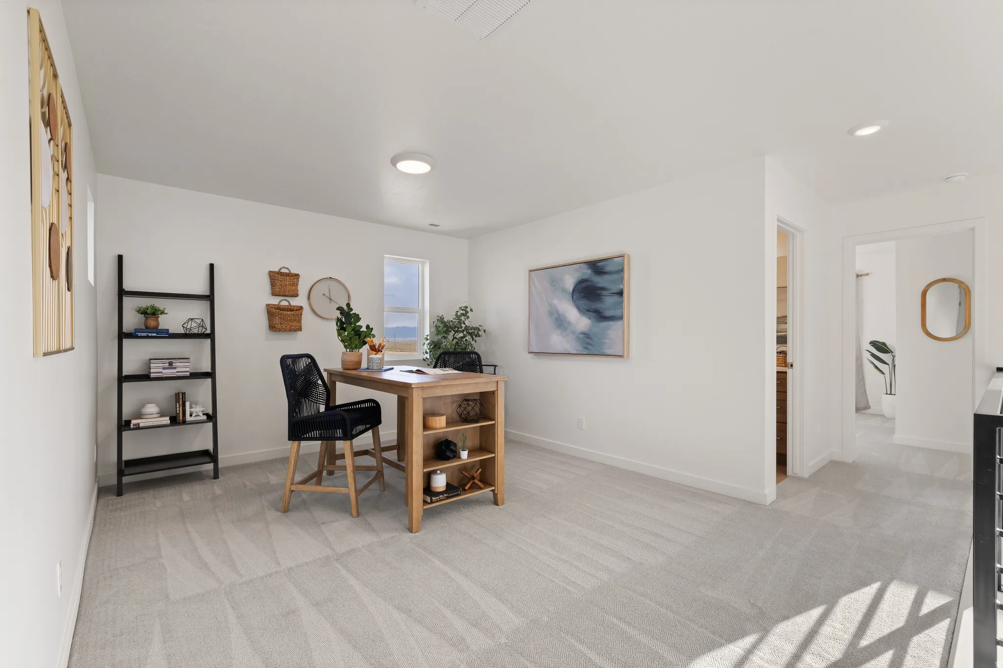 Brightly lit room featuring neutral carpeting, a window, and recessed lighting