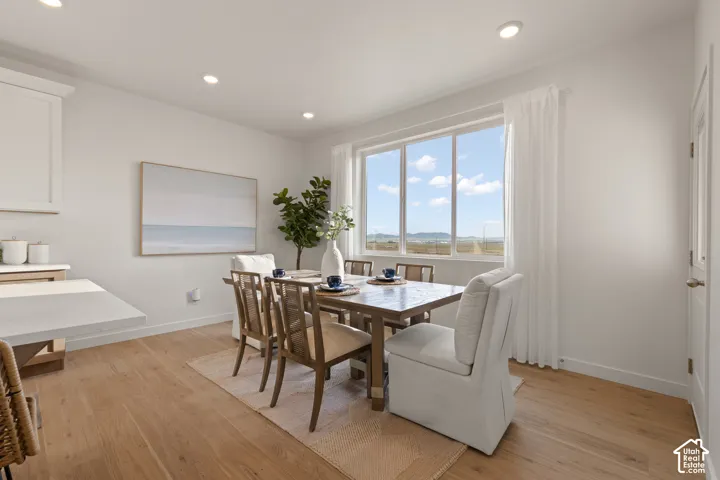Expansive window with distant scenery, wood-finish flooring, recessed lighting, and a built-in countertop extension