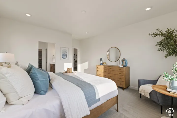 Recessed ceiling lighting, light-toned carpeting, ample wall space, and interior doorways