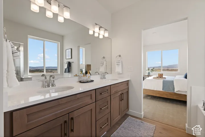 Double vanity with dual undermount sinks, integrated countertop, and modern wood-finish cabinetry