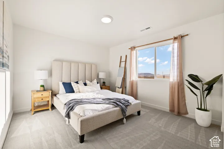 Neutral wall color, recessed lighting, expansive window, light gray carpeting, and white trim